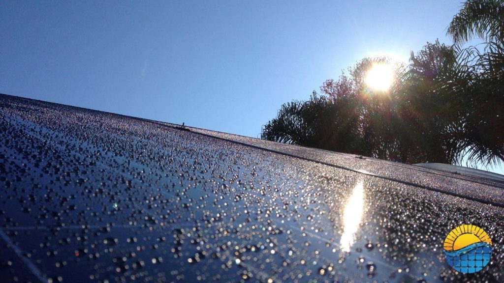solar panels on the roof of a house after a rain