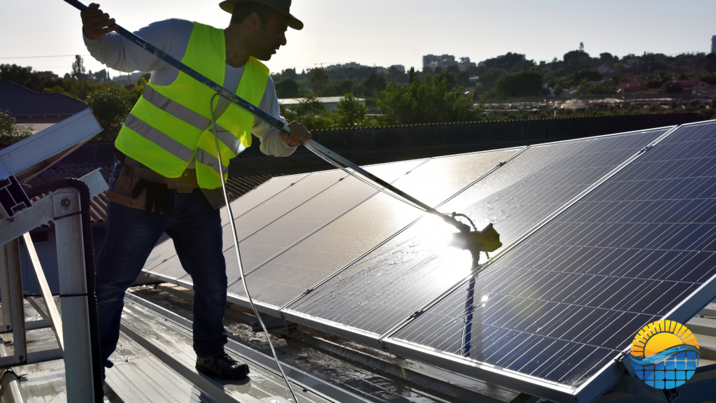 A person cleaning solar panels on the roof of a building