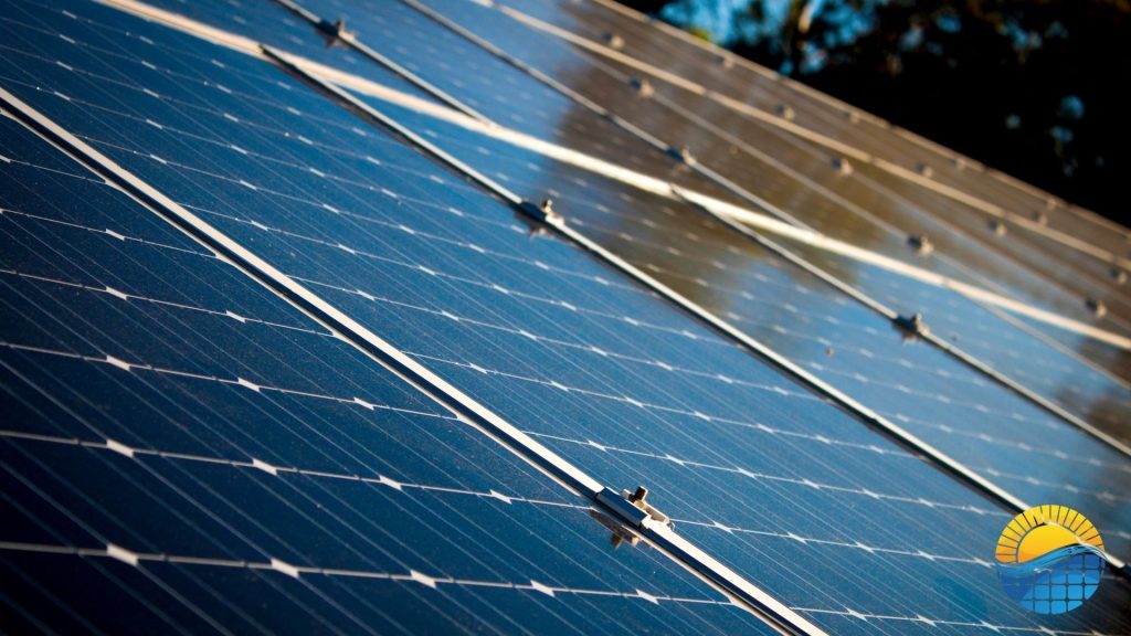 a close up of a clean solar panel with trees in the background